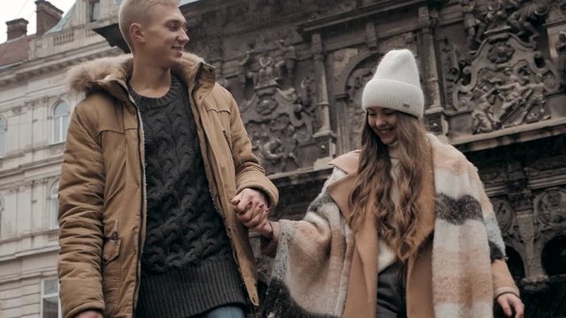young man and woman walking in winter