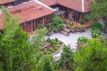 Amazing view of buddhist monastery and courtyard garden with flowers and bonsai trees in Bana hill, tourism site in Da Nang, Vietnam