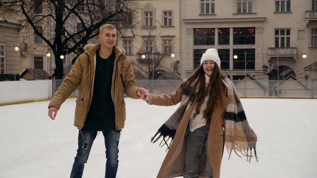 young couple on the ski rink in winter
