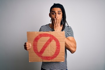 Young handsome african american man with dreadlocks holding banner with prohibited signal cover...