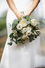 Wedding bouquet of bride that she holds in her hands