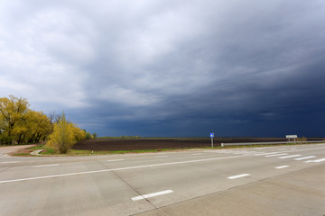 Fototapeta premium thunderclouds over an asphalt road