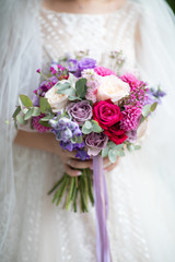 Wedding bouquet of bride that she holds in her hands