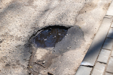 Hole in the pavement on the road