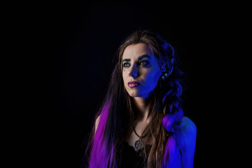 Girl in werewolf style on a black background with blue light