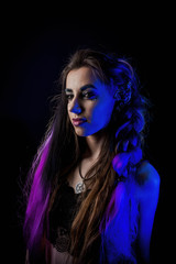 Girl in werewolf style on a black background with blue light