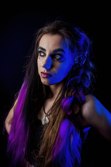 Girl in werewolf style on a black background with blue light