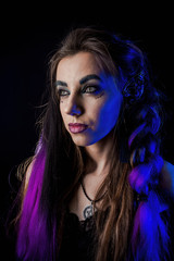 Girl in werewolf style on a black background with blue light