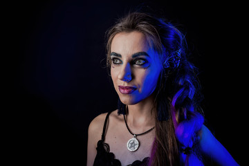 Naklejka na ściany i meble Girl in werewolf style on a black background with blue light