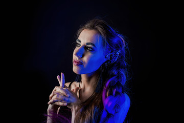 Girl in werewolf style on a black background with blue light