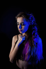 Fototapeta na wymiar Girl in werewolf style on a black background with blue light