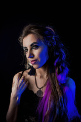 Fototapeta premium Girl in werewolf style on a black background with blue light