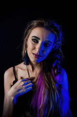 Girl in werewolf style on a black background with blue light