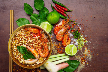 Delicious Malaysian Soup with prawn and coconut milk,Tom Yum Kung shrimp soup and herb ingredient Thai food with decoration around,Ingredients for popular Thai soup Tom-yum kung. Lime, galangal, red c
