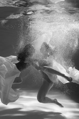 Obraz premium Two beautiful lesbian girls are swimming underwater. Attractiveness. Sexual poses and gestures. Female dance underwater. Swimwear and pool. Two mermaids. Two girlfriends women.Gay girls. Same-sex love