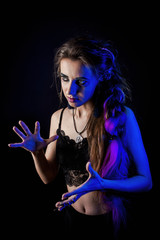 Girl in werewolf style on a black background with blue light