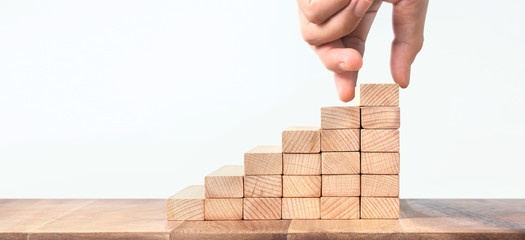 Hand liken person stepping up  toy staircase wood