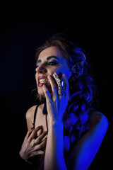 Girl in werewolf style on a black background with blue light