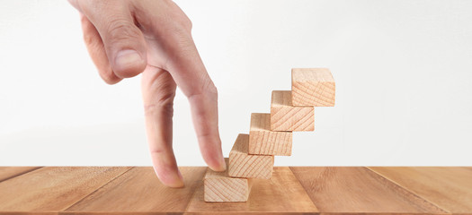 Hand liken person stepping up  toy staircase wood