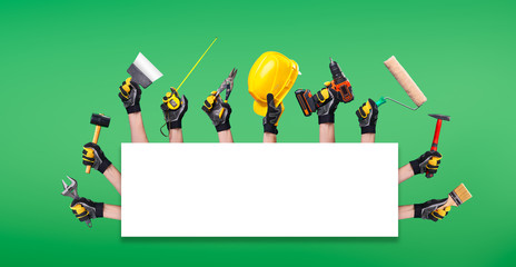 Hands of workers with different tools on blank green background in studio