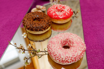 multi-colored donuts on a mirror surface