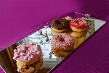 multi-colored donuts on a mirror surface