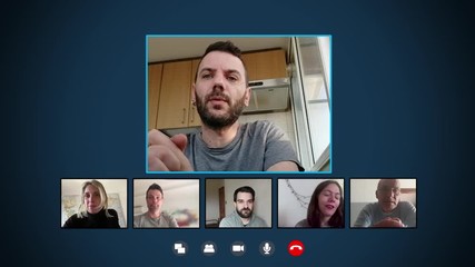 Young man in video call on skype telling friends his day