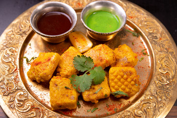 nuggets and sauce on indian dish 
