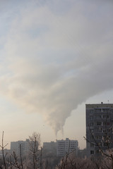 View of smoke from chimneys on a winter day