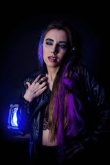 Girl in werewolf style on a black background with blue light.