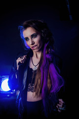 Naklejka premium Girl in werewolf style on a black background with blue light.