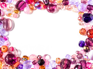 Beads background. Colorful beads in pink, purple, red, violet and lila colors on white