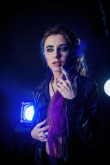 Girl in werewolf style on a black background with blue light.