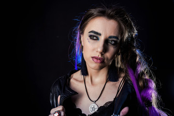 Girl in werewolf style on a black background with blue light.