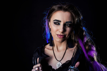 Girl in werewolf style on a black background with blue light.