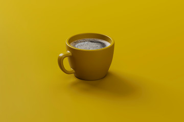 Yellow cup of coffee isolated on a yellow background