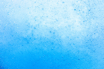 Soapy foam of blue color close-up, toning
