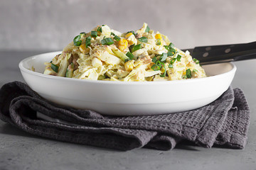 Fresh vegetable salad with cabbage, canned cod liver, sweet corn, cucumber and quail eggs. Healthy balanced diet. 