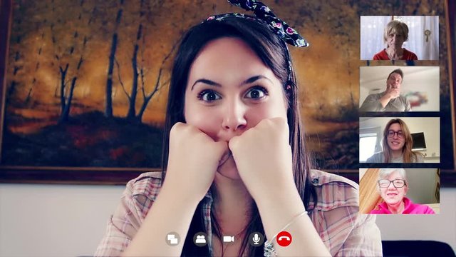 young  woman in video call by skype talking to distant relatives and friends