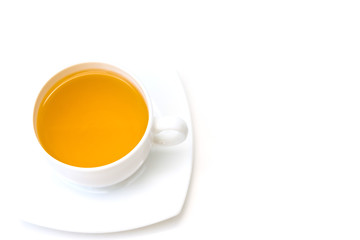 White porcelain cup with freshly brewed green tea isolated on white background