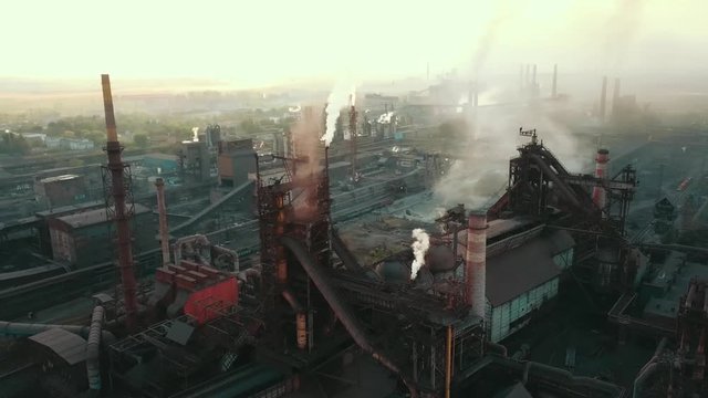 Industrial production plant metallurgical steel aerial video 4K smoke from chad pipes.