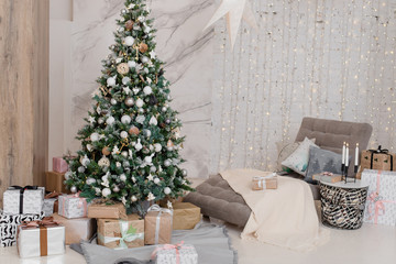 Big Christmas tree with gifts in a white room