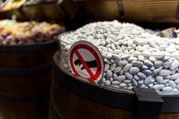 Chocolate candy with white icing in a wooden barrel with a sign