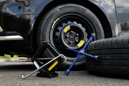 A spare tire and lug wrench and jack, following a tire puncture