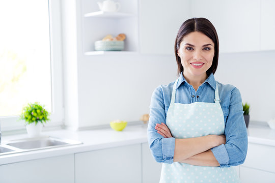 Portrait of independent smart reliable house wife ready clean do chores duties cook meal dish cross hands wear denim jeans shirt in house indoors kitchen
