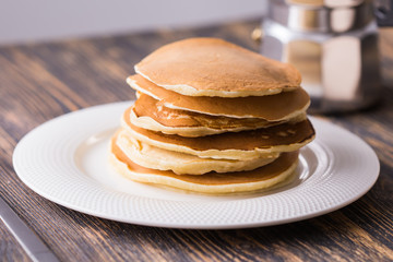Fototapeta na wymiar Homemade delicious pancakes on white plate. Breakfast concept