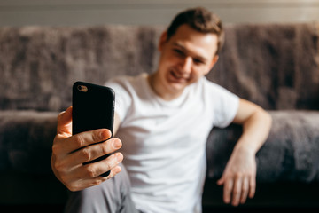 Happy man using phone.Concept of young people working mobile devices. Focus on phone