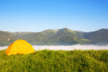 bright yellow tourist tent in the mountains nature