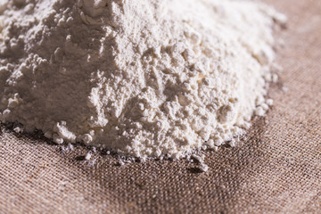 Fototapeta na wymiar White flour on textile background texture photo