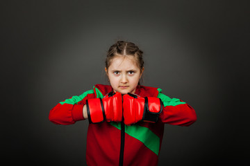 Beautiful little girl boxer in gloves ready to fight.